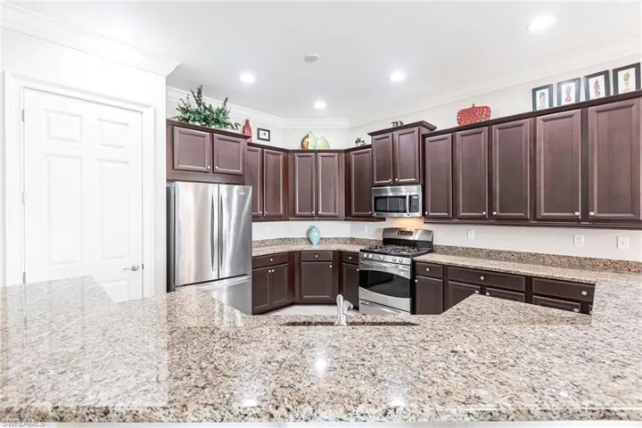 Kitchen with plenty of cabinetry, pantry and stainless steel appliances.