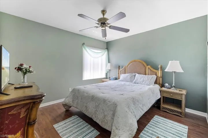 Bedroom with baseboards, ceiling fan, and wood finished floors