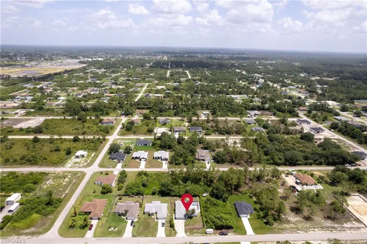 Aerial overview of property's location with nearby suburban area