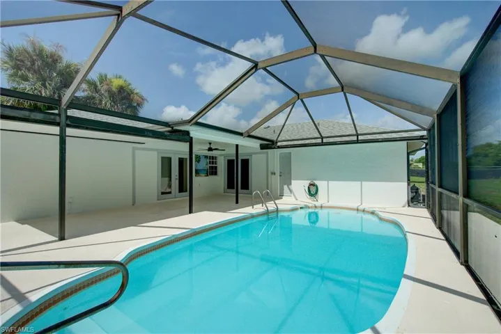 Outdoor pool with french doors, a patio area, ceiling fan, and a lanai