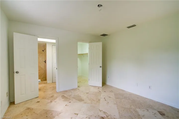 Unfurnished bedroom featuring a spacious closet and a closet