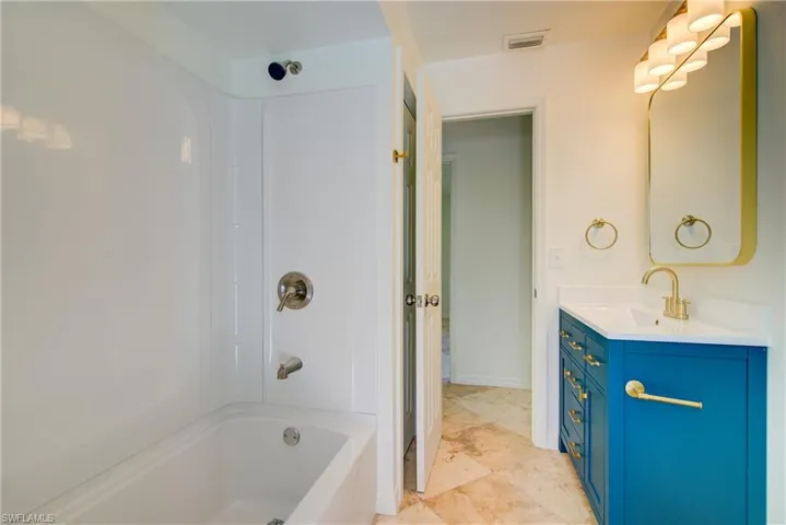 Full bathroom with vanity and bathing tub / shower combination