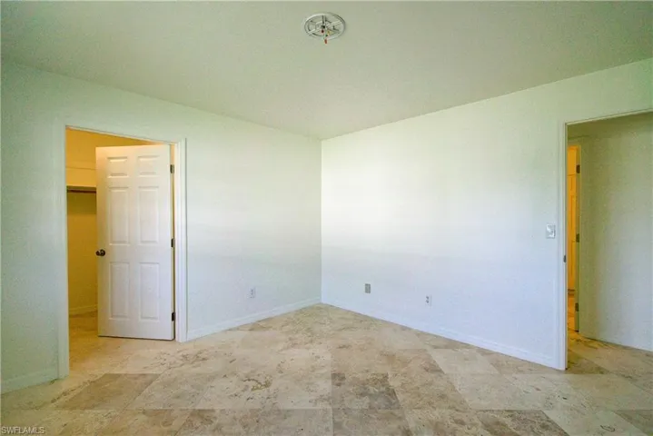 Spare room featuring baseboards