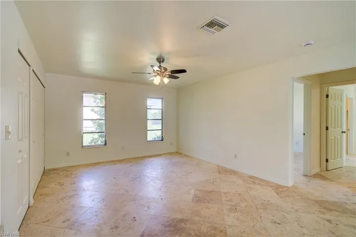 Unfurnished bedroom with baseboards and a ceiling fan