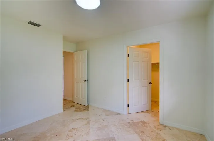Unfurnished bedroom with baseboards