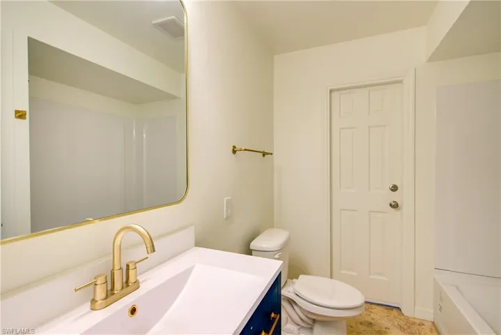 Full bath featuring vanity and a tub