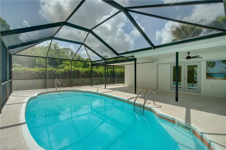 Outdoor pool with french doors, a patio area, and ceiling fan