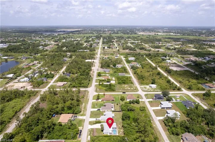 Aerial view of property's location with a large body of water