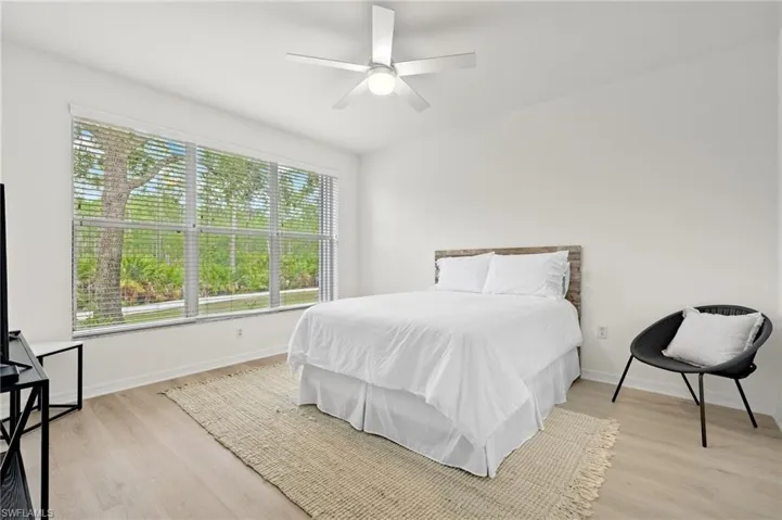 Bedroom with light hardwood / wood-style floors and ceiling fan