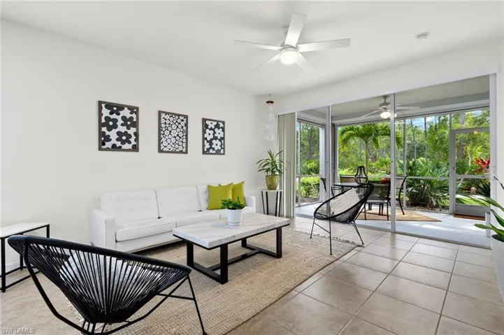 Tiled living room featuring ceiling fan