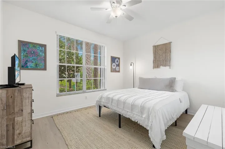 Bedroom featuring light hardwood / wood-style floors and ceiling fan