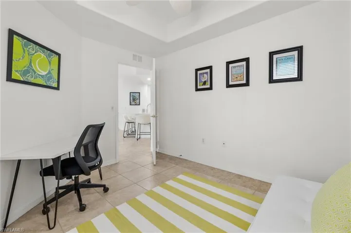Home office featuring ceiling fan and light tile patterned floors