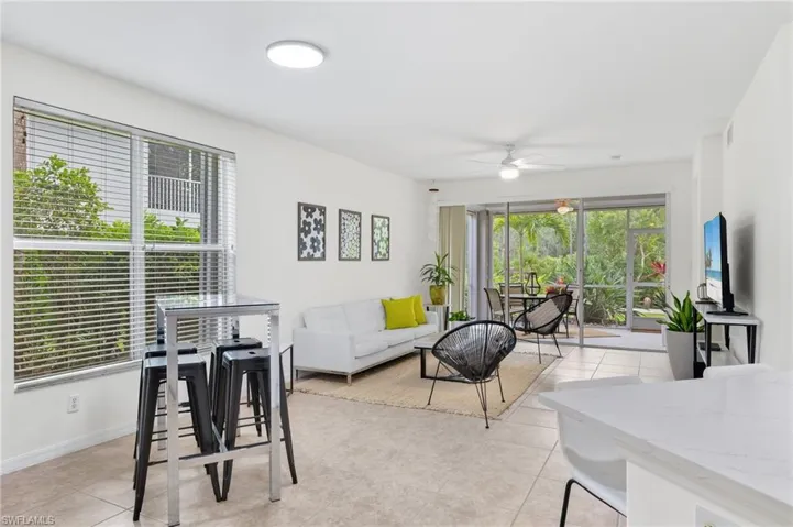 Tiled living room featuring ceiling fan