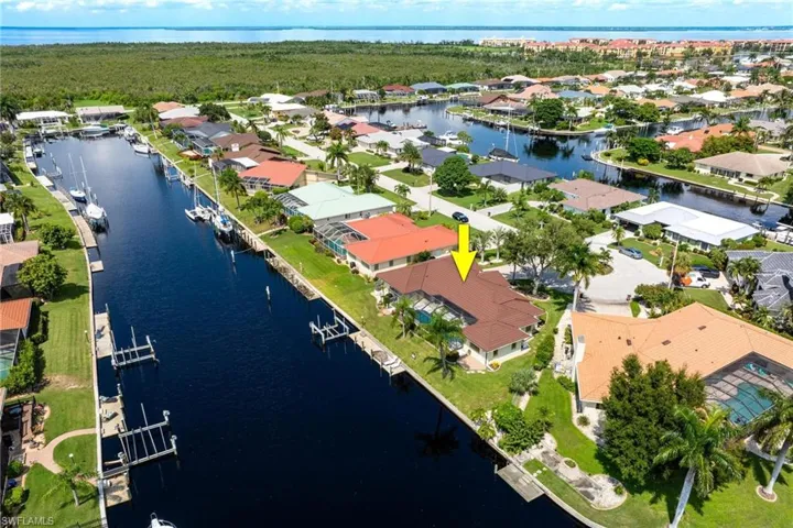 Birds eye view of property with a water view