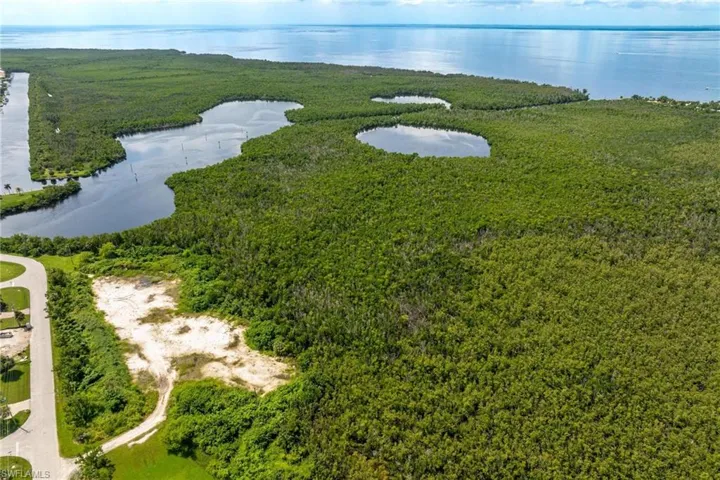 Birds eye view of property with a water view