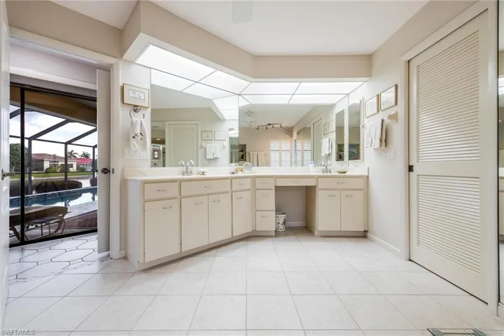 Bathroom featuring a healthy amount of sunlight, tile patterned flooring, and vanity