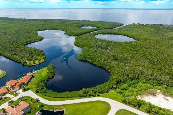 Birds eye view of property with a water view