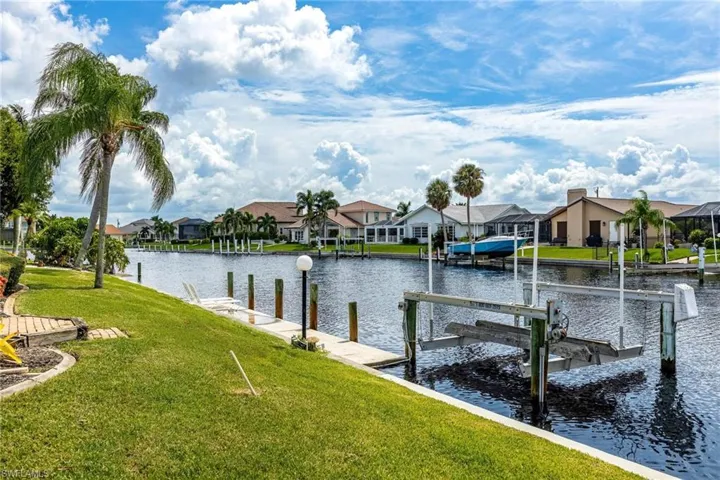 Dock area featuring a yard and a water view