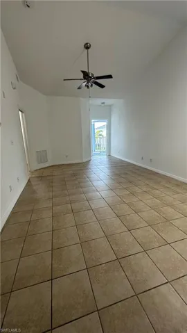 Unfurnished room with baseboards, a ceiling fan, tile patterned flooring, and visible vents