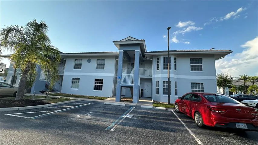 View of property with uncovered parking