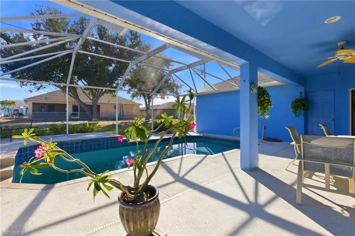 View of swimming pool with patio surround, a sunroom, and a lanai
