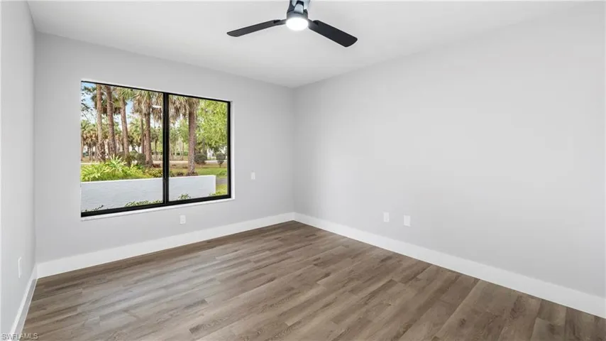 Spare room featuring wood finished floors and a ceiling fan