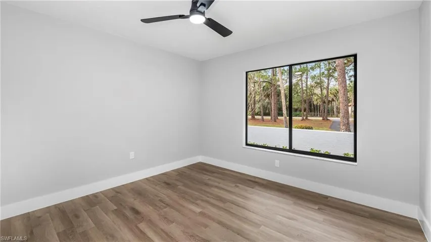 Unfurnished room featuring wood finished floors and a ceiling fan