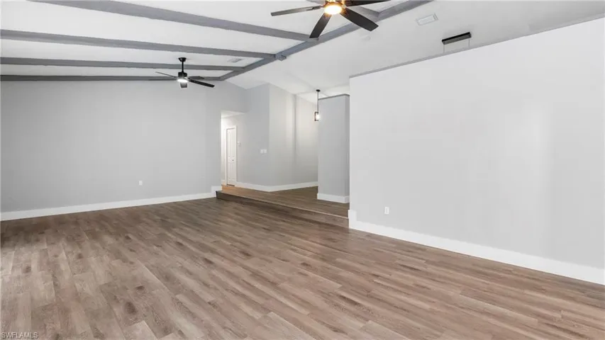 Empty room with light wood-style flooring and ceiling fan