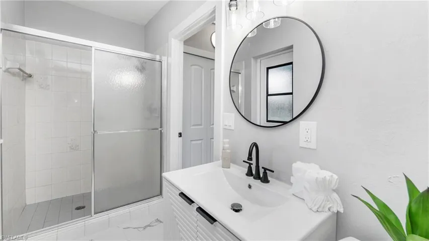 Full bath with vanity and a stall shower