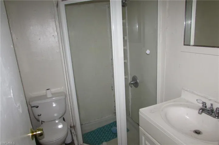 Bathroom with a shower, vanity, and toilet