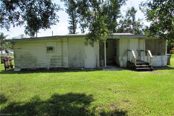 Rear view of property featuring a yard