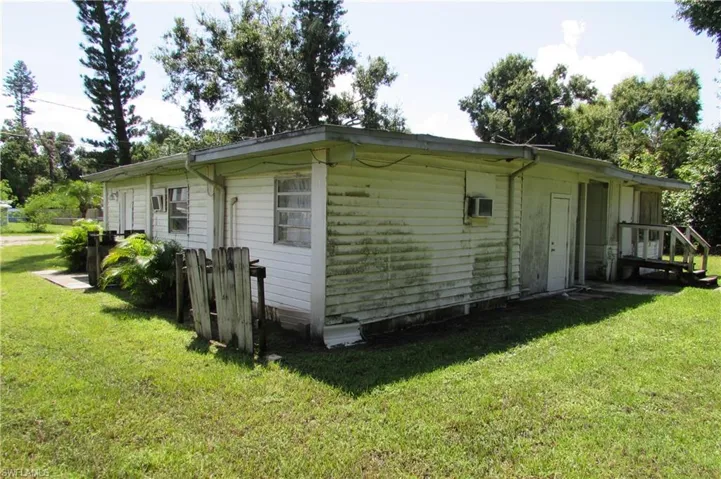 View of property exterior with a yard