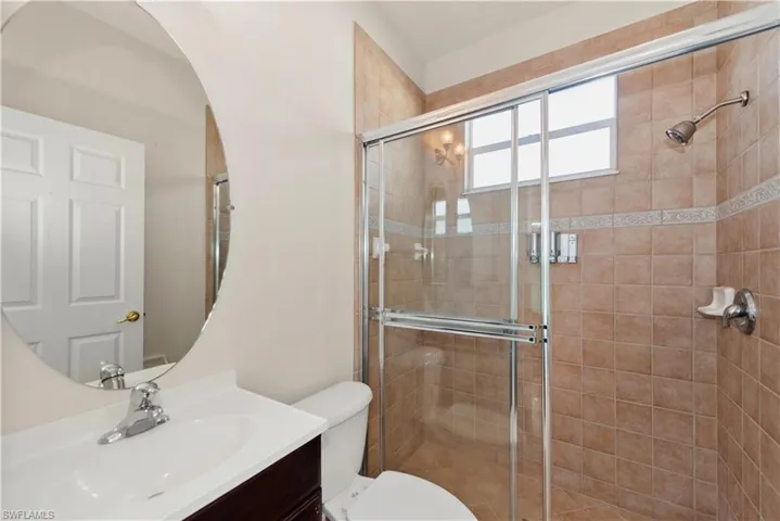 Full bath with vanity and a shower stall