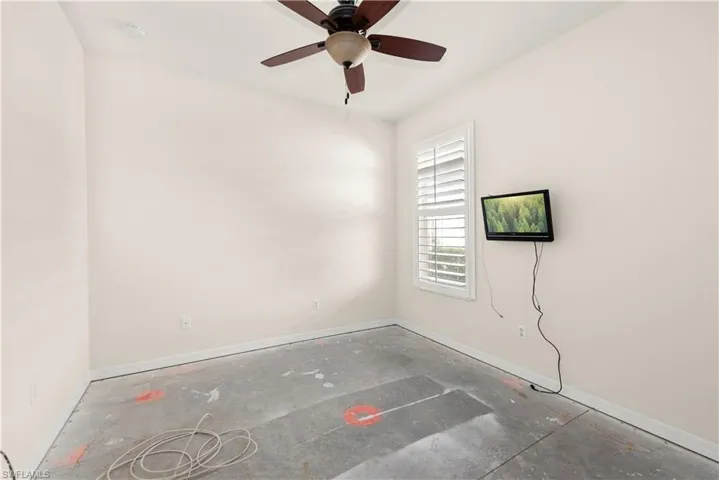 Spare room featuring baseboards and a ceiling fan
