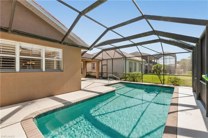 Outdoor pool featuring a patio, a sunroom, and a lanai
