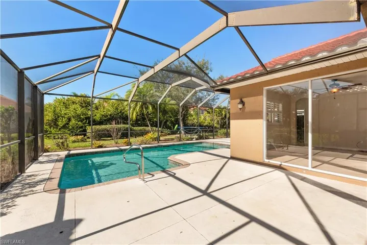 Swimming pool featuring a patio area, a lanai, and a sunroom