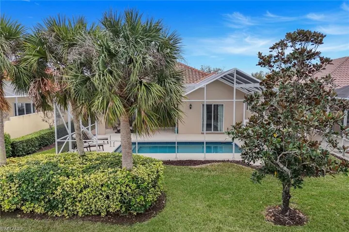 View of pool featuring a lanai, a patio, and a yard