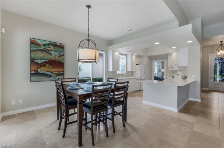 Dining space featuring an inviting chandelier and sink