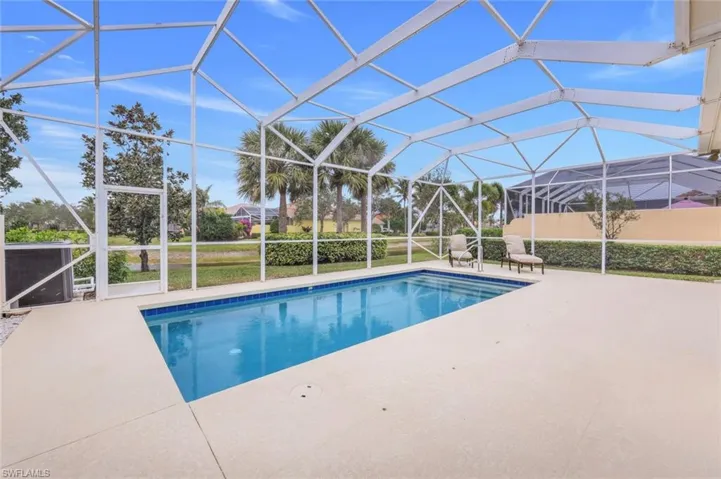 View of swimming pool featuring a lanai and a patio