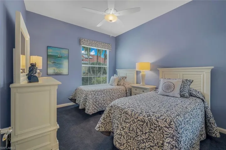 Carpeted bedroom featuring ceiling fan