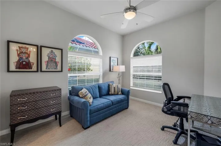 Office area featuring ceiling fan, light carpet, and a healthy amount of sunlight