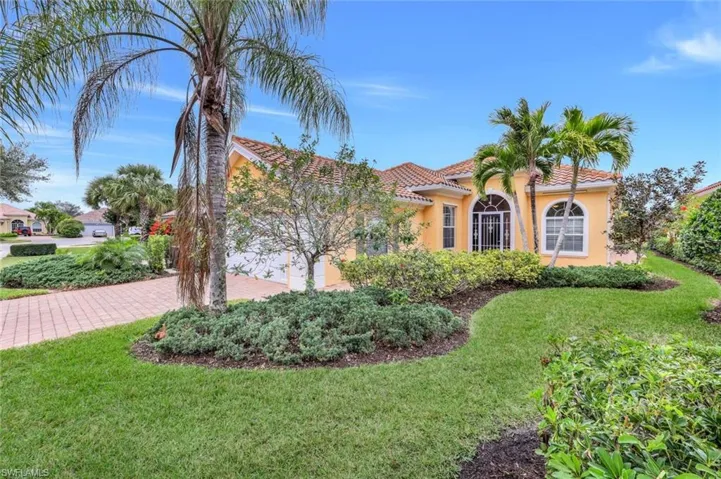 Mediterranean / spanish house featuring a garage and a front yard