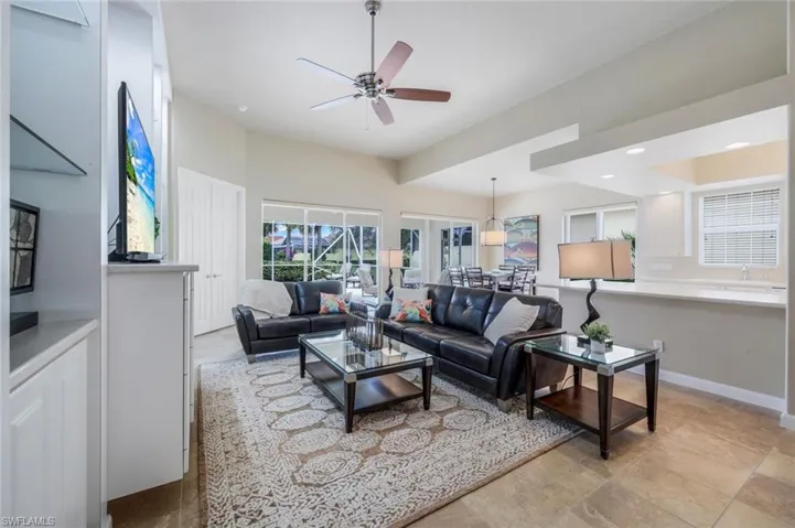 Living room with ceiling fan and french doors
