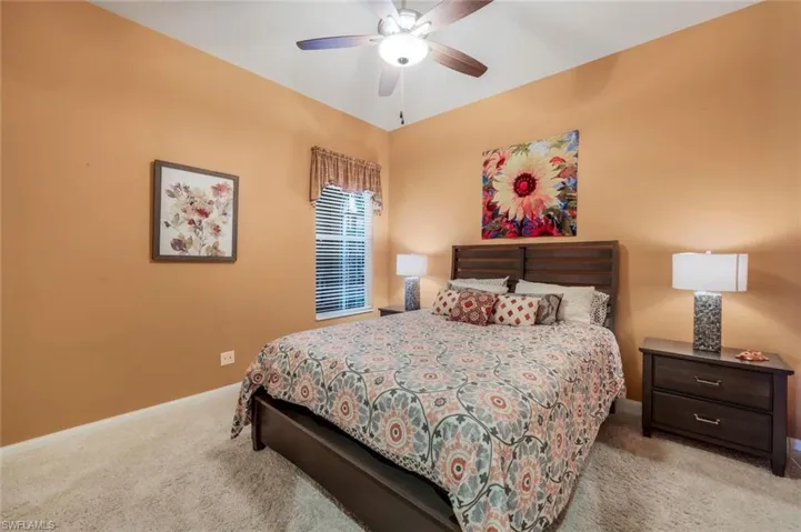 Carpeted bedroom with ceiling fan