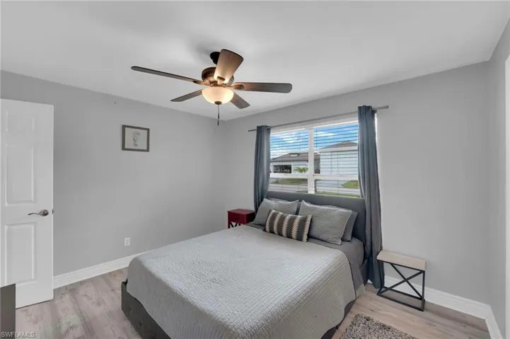 Bedroom with light wood-type flooring and a ceiling fan