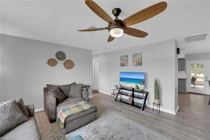 Living area featuring wood finished floors and a ceiling fan