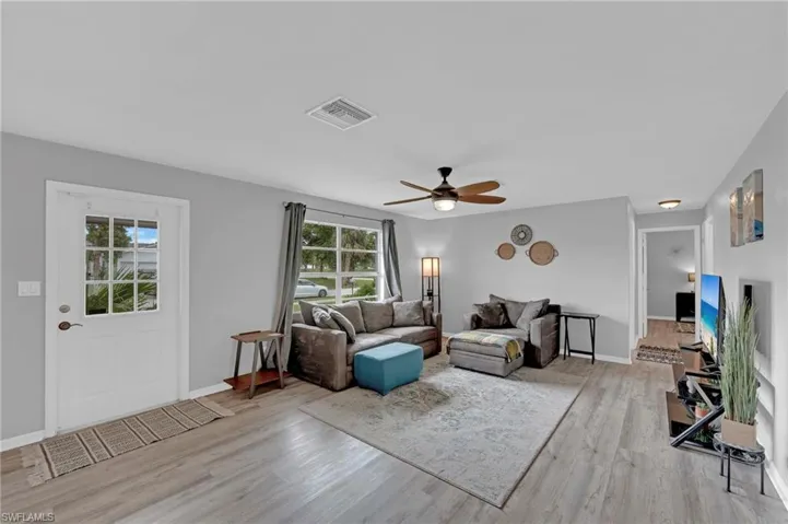 Living room featuring light wood-type flooring and ceiling fan