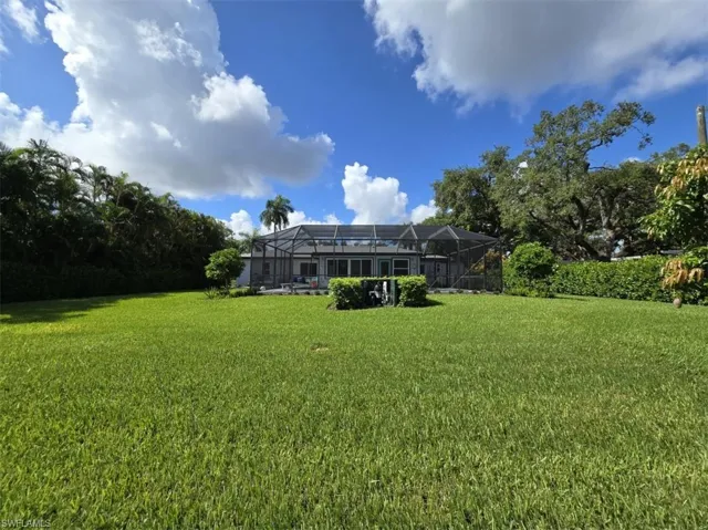 View of yard featuring glass enclosure