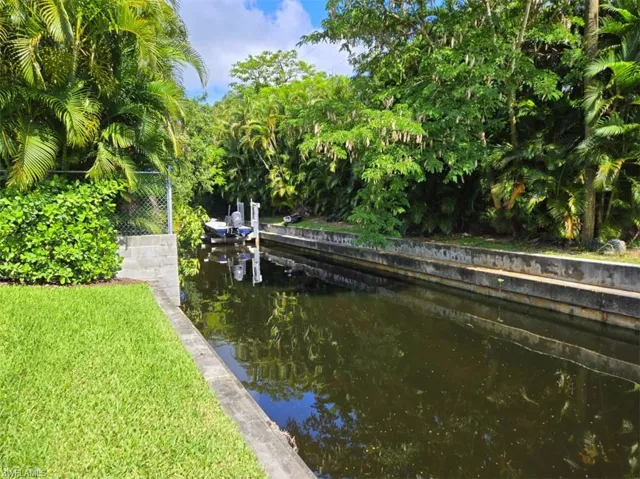 View of dock with a lawn