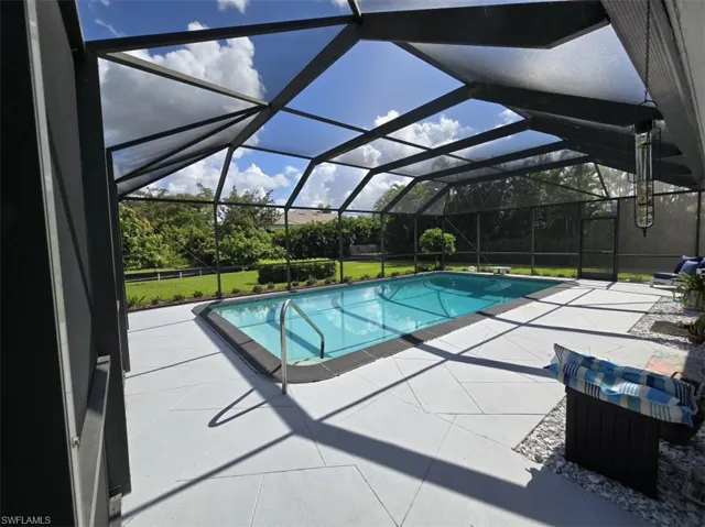View of pool with a lanai and a patio